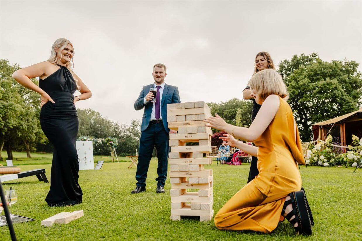 Wedding guests playing garden games at an outdoor reception