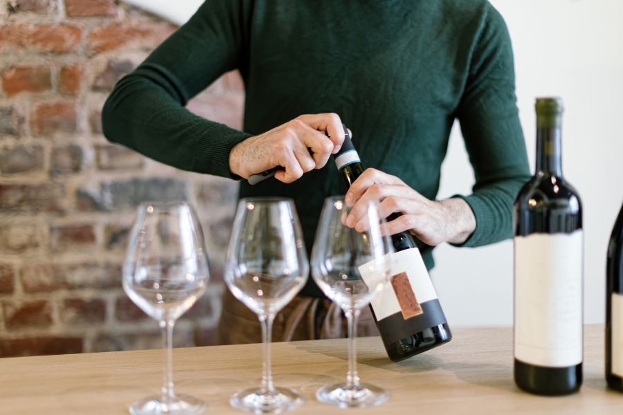 Wine connoisseur leading a tasting at an elegant 60th birthday celebration