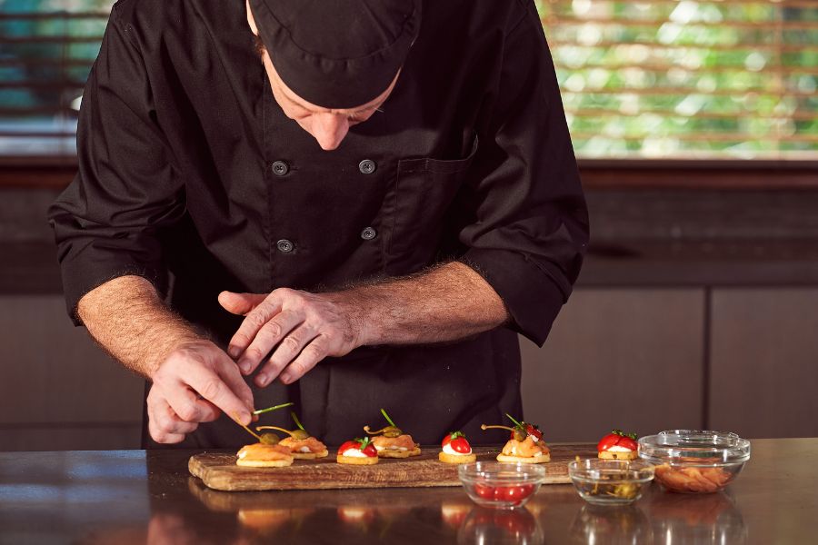 Private chef preparing food at a 60th birthday dinner party