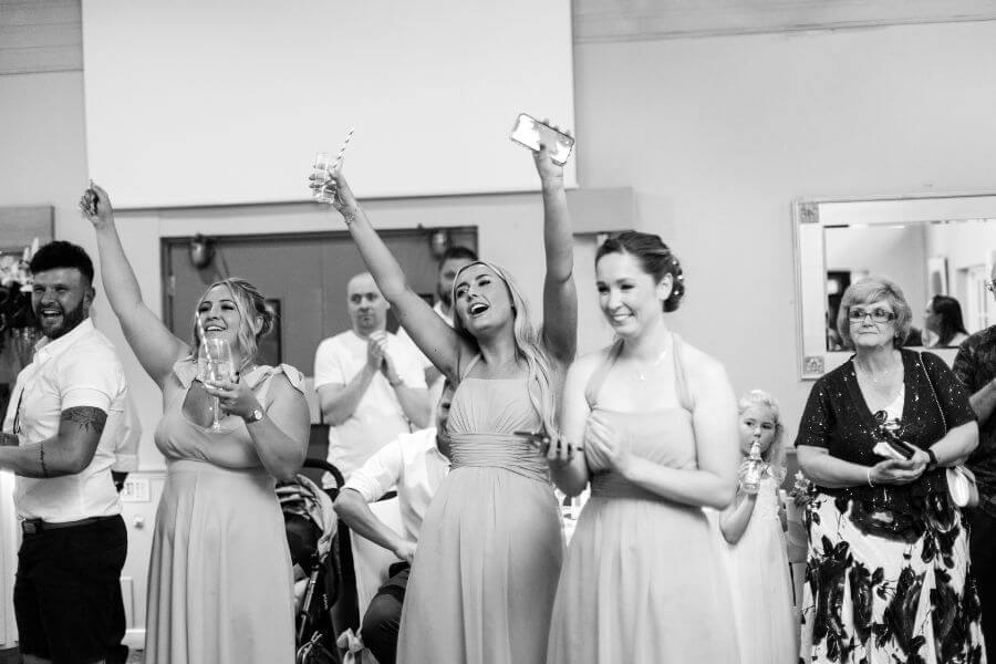 Wedding guests mid-round during the stand up, sit down game
