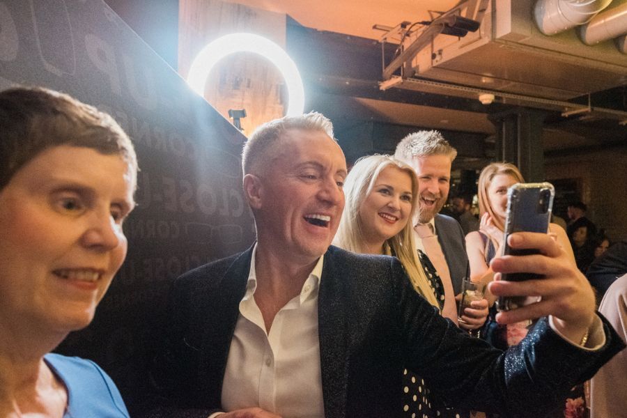 Guests laughing during a close-up magic performance