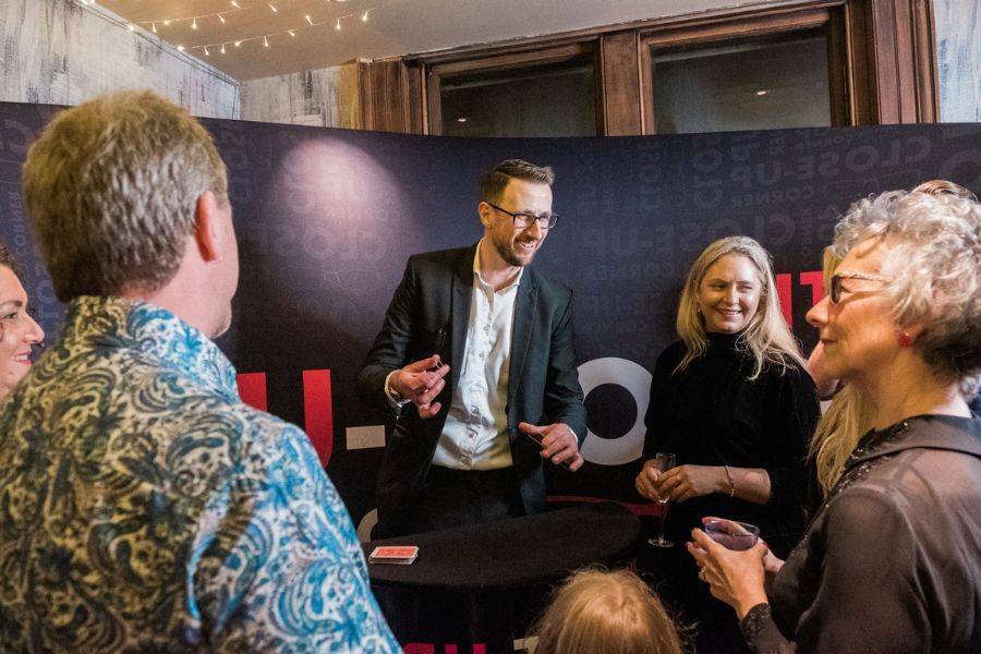 Guests watching close-up magic up close