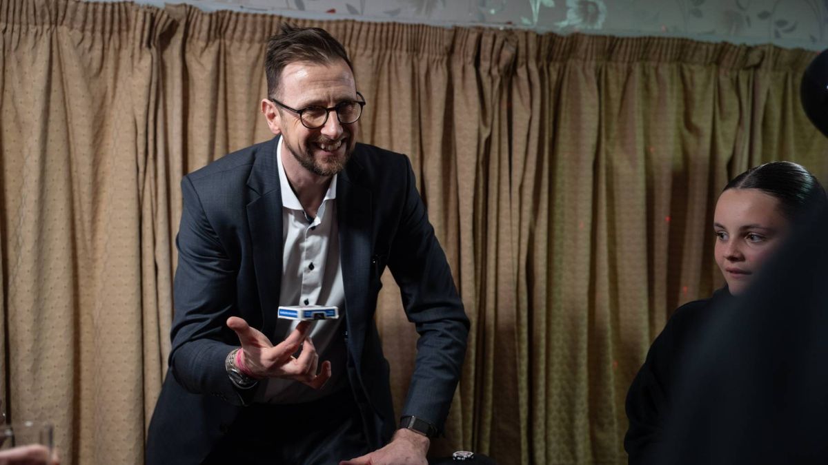 A close-up magician performing with cards