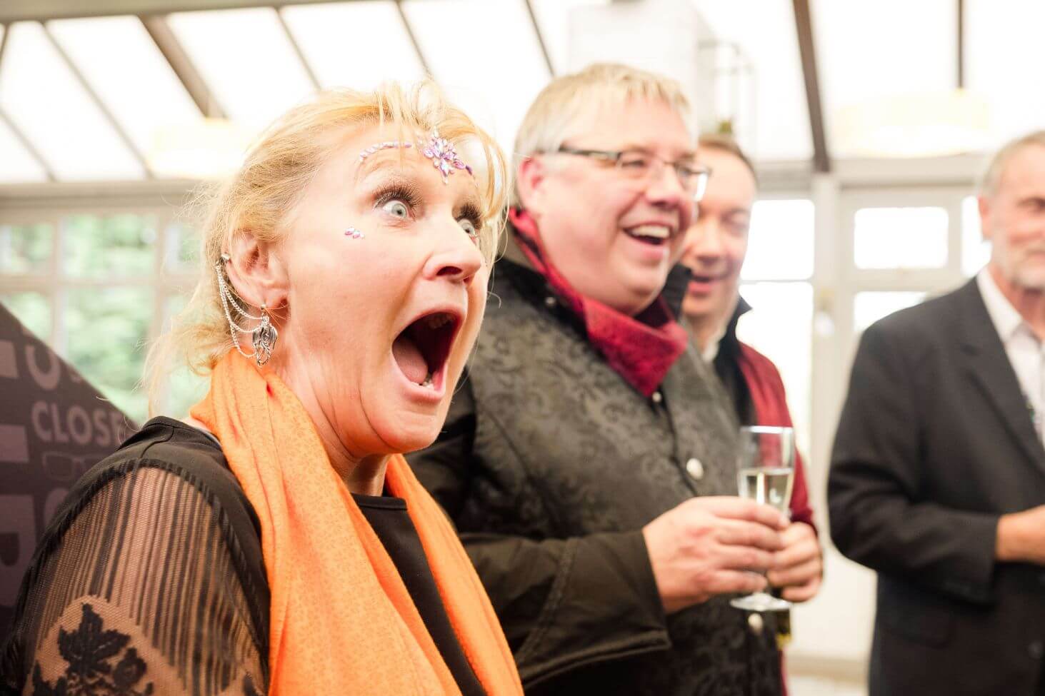 Corporate event magician — guests reacting to close-up magic