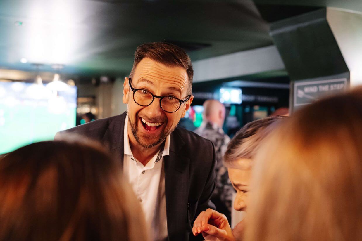 Guests wowed by close-up magic at a party