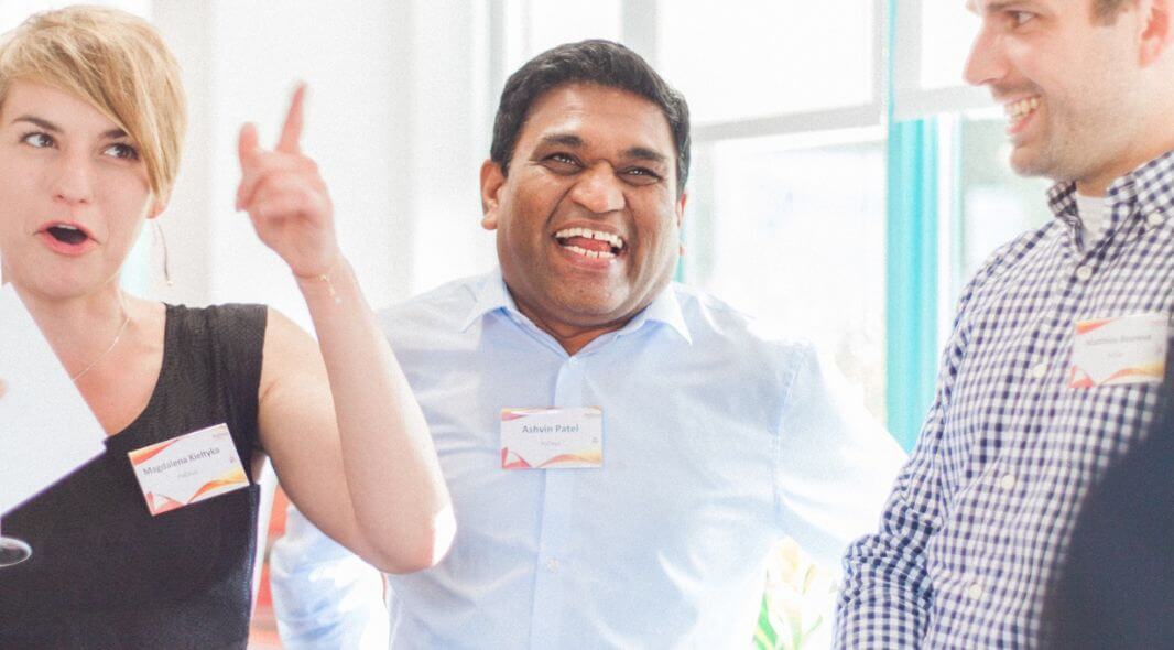 Guests reacting to close-up magic at a corporate dinner