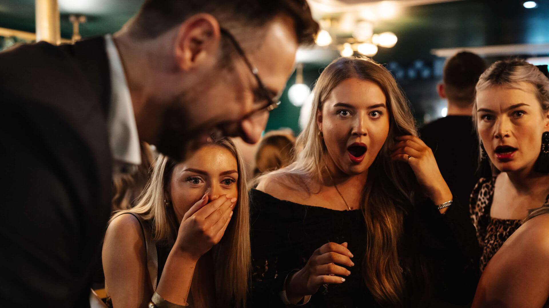 Guests reacting to close-up magic at the Close-Up Corner
