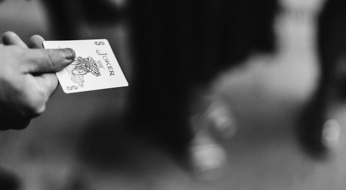 A wedding magician entertaining seated guests