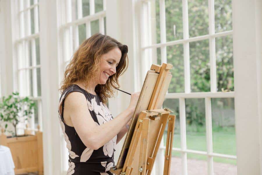 Live artist painting guests at a Christmas party