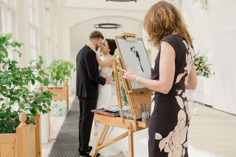 Live event painter capturing the atmosphere at a corporate Christmas event