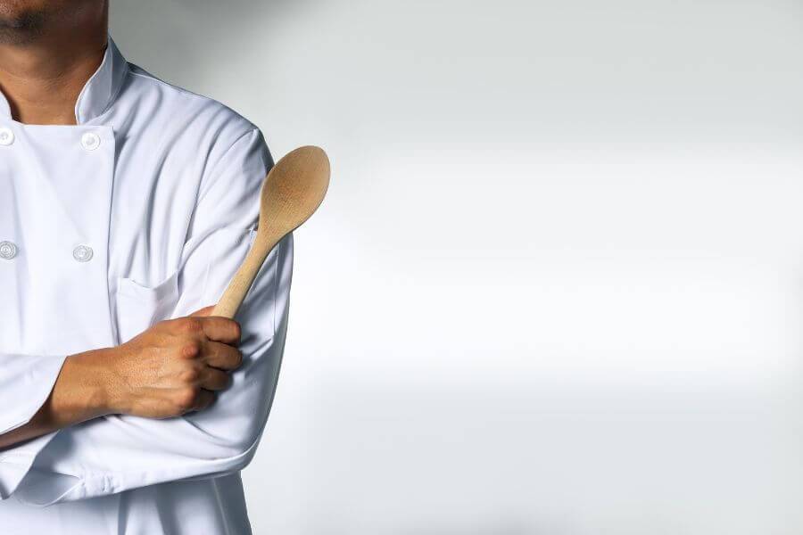 A private chef plating a course at a dinner party