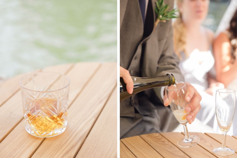 A whiskey cocktail and a glass of champagne being poured at a wedding reception