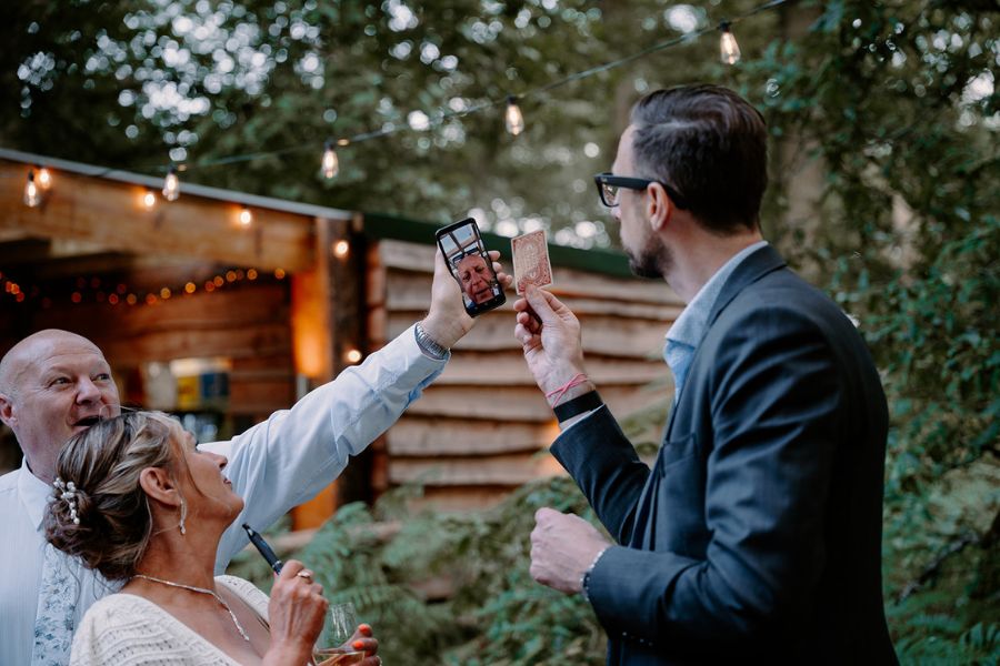 Close-Up Chris performing magic at an outdoor wedding reception