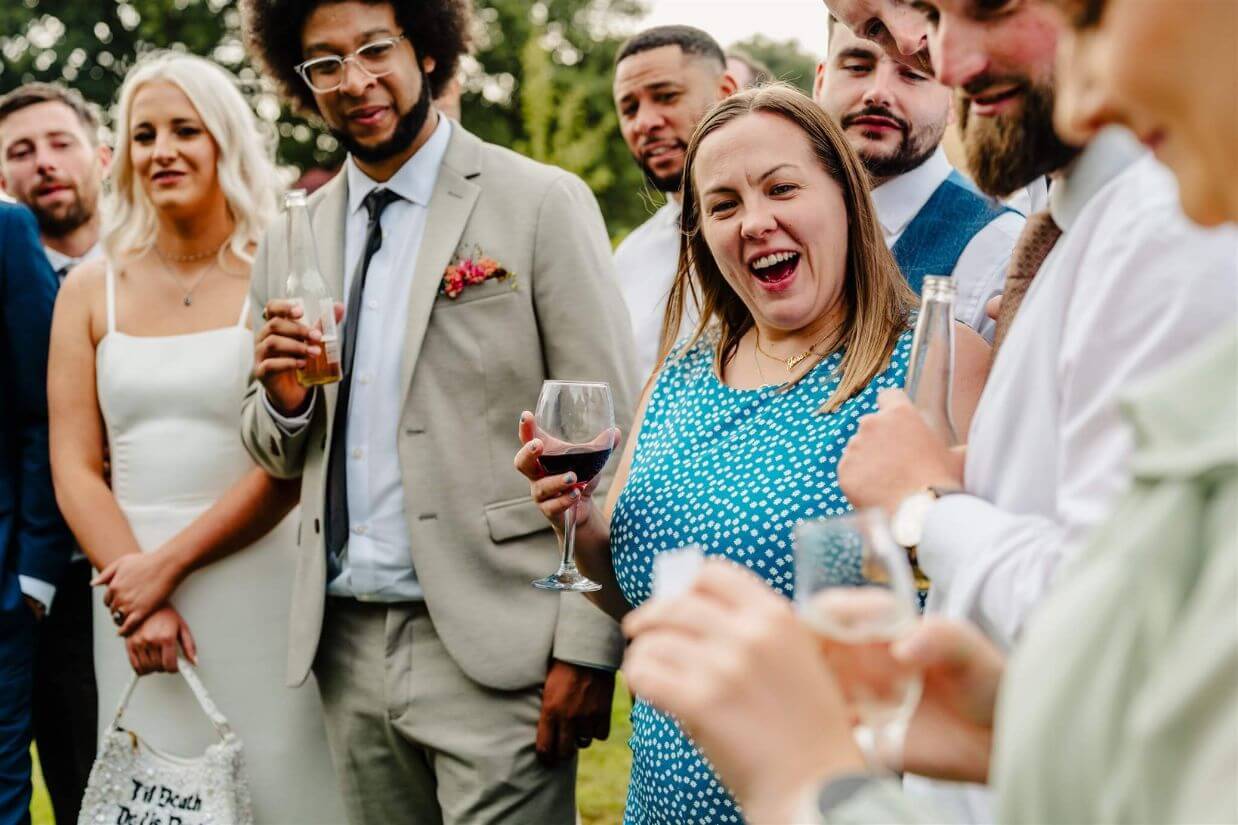 Close-up magic at a wedding tipi reception, guests laughing