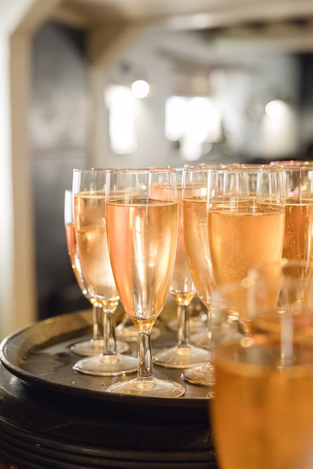 Champagne glasses filled and lined up for the wedding breakfast toast