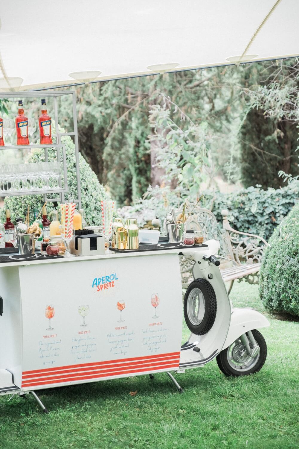 A vintage garden drinks cart serving spritzes and Pimm's at a summer wedding