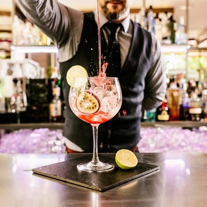 Wedding cocktail masterclass with a mixologist teaching guests