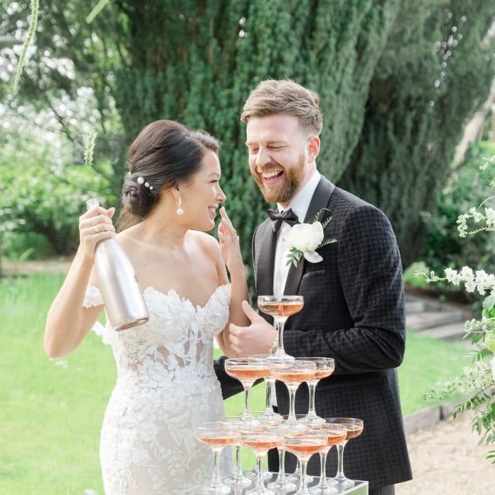 Wedding guests watching a champagne tower pour