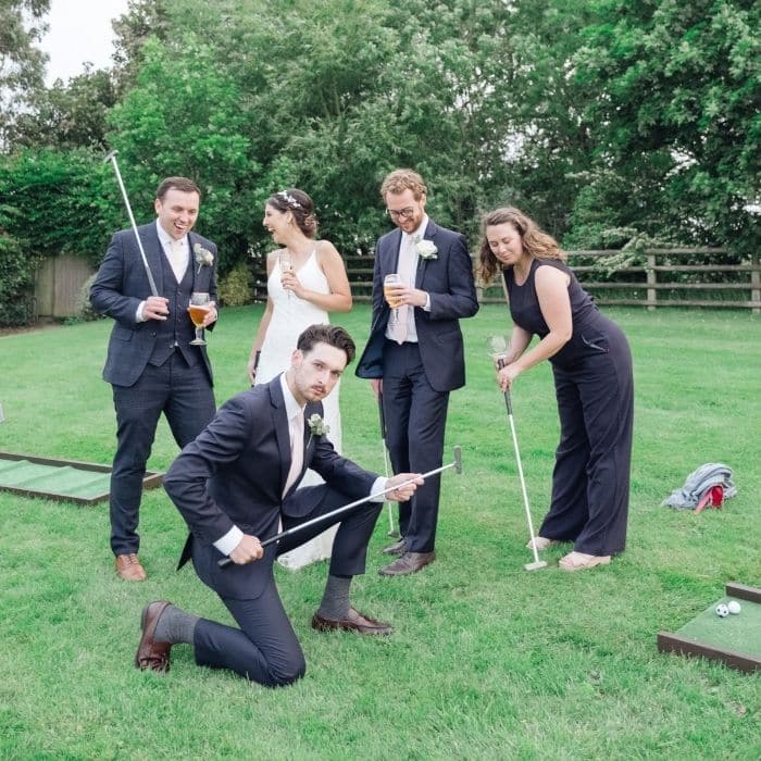 Wedding guests playing giant garden chess on the lawn during the drinks reception