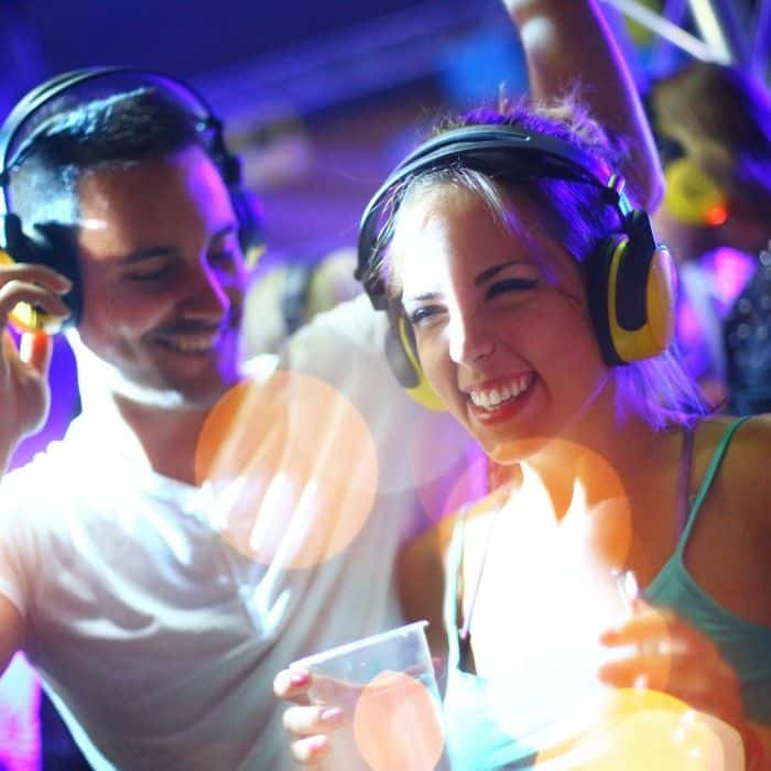 Wedding silent disco with guests wearing headphones on the dance floor