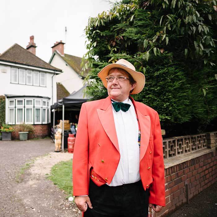 Comedy waiter serving wedding guests with mock canapes