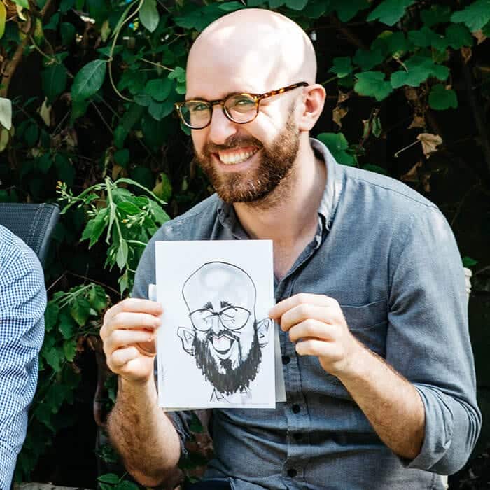 Caricaturist sketching a guest at a corporate event