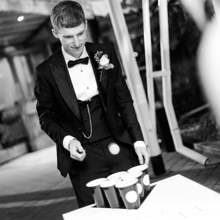 Wedding guests playing beer pong at the evening reception