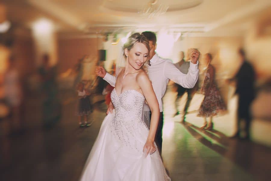 Ceilidh band performing with wedding guests dancing in a circle