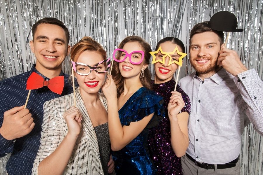 A photo booth at a corporate event with guests posing