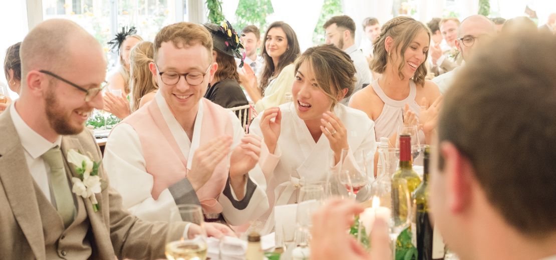 Wedding breakfast table magic — couple reacting