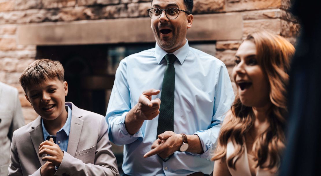 Wedding guests reacting to close-up magic