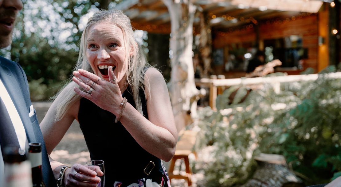 Shocked wedding guest reacting to close-up magic