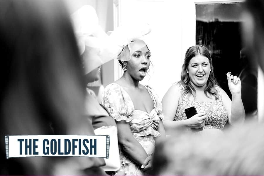 Wedding guest with mouth open in silent amazement at close-up magic