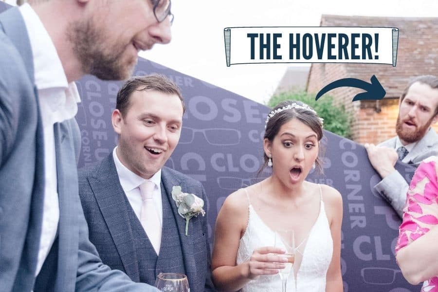 Wedding guest watching from the edge of a close-up magic performance