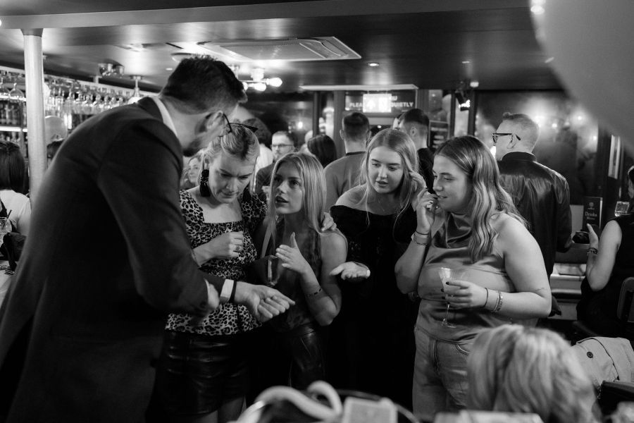 Close-up magic at an evening fundraiser dinner