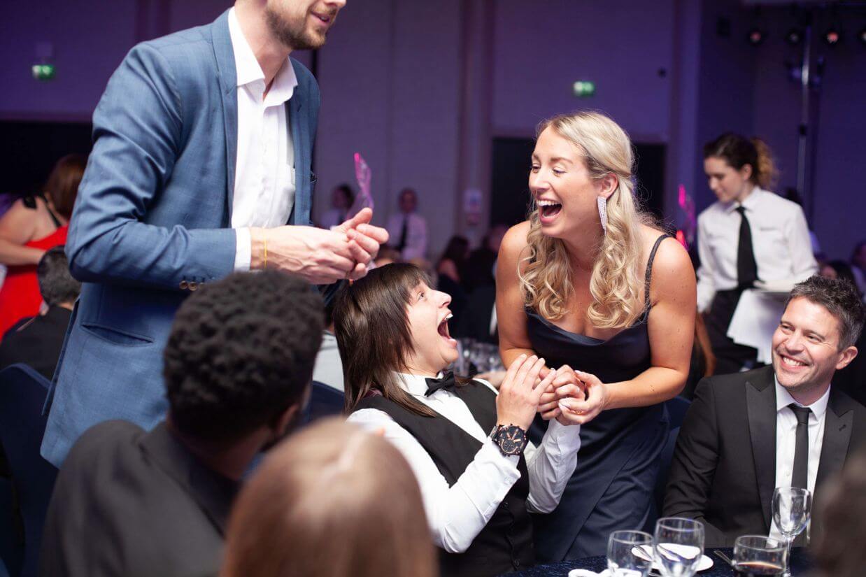 Table magician performing close-up magic for seated guests