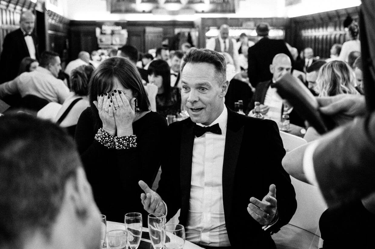 Professional table magician performing close-up magic at a seated dinner