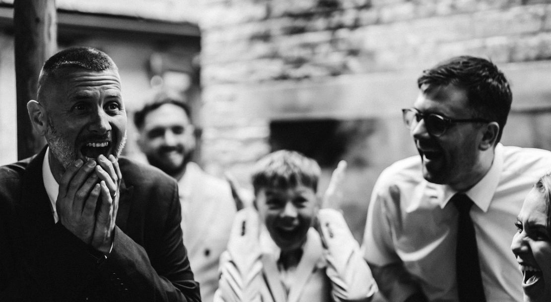 A group laughing together during close-up magic
