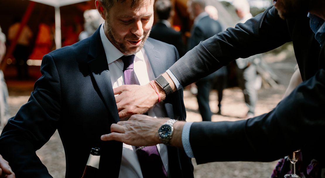Close-up magician entertaining wedding guests in the evening