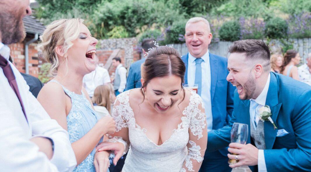 Wedding guests laughing at close-up magic