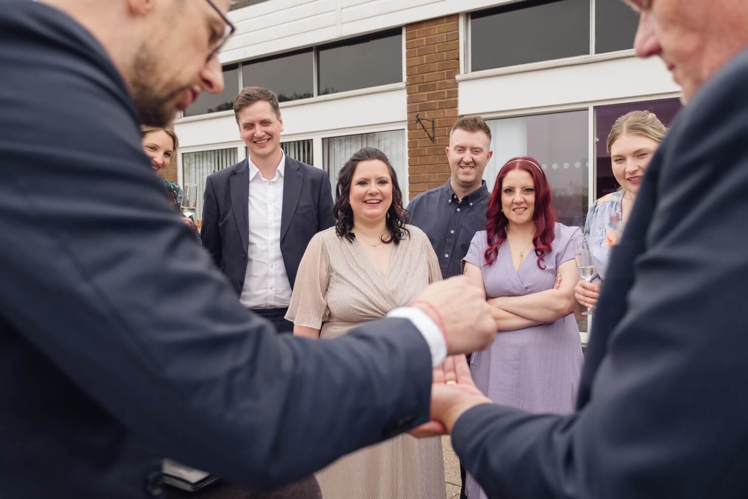 Wedding guests reacting to a card trick at Harborne Golf Club