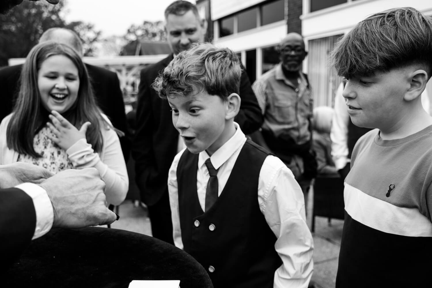 Close-Up Chris performing a card trick for wedding guests at Harborne Golf Club