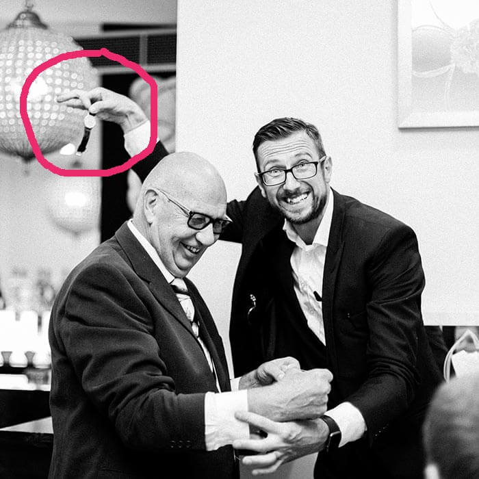 How to steal a watch 16 Magician dangling the stolen watch behind the guest's back
