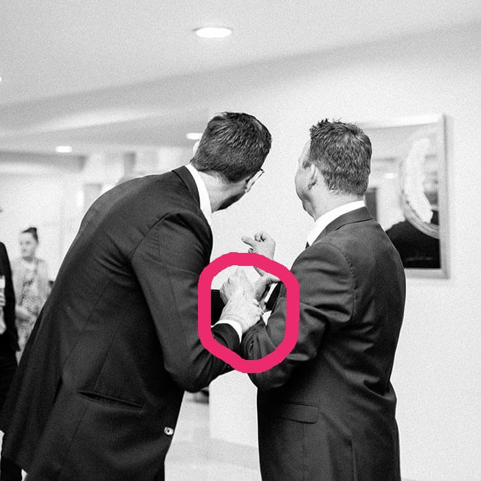 Guest believes the magician is holding his wrists for the band trick