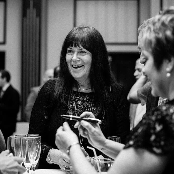 guests laughing at corporate dinner