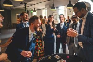 husband laughing with magician