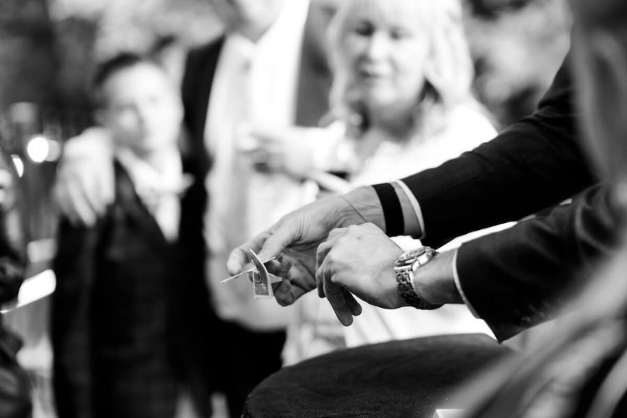 Wedding guests reacting to a sleight of hand routine