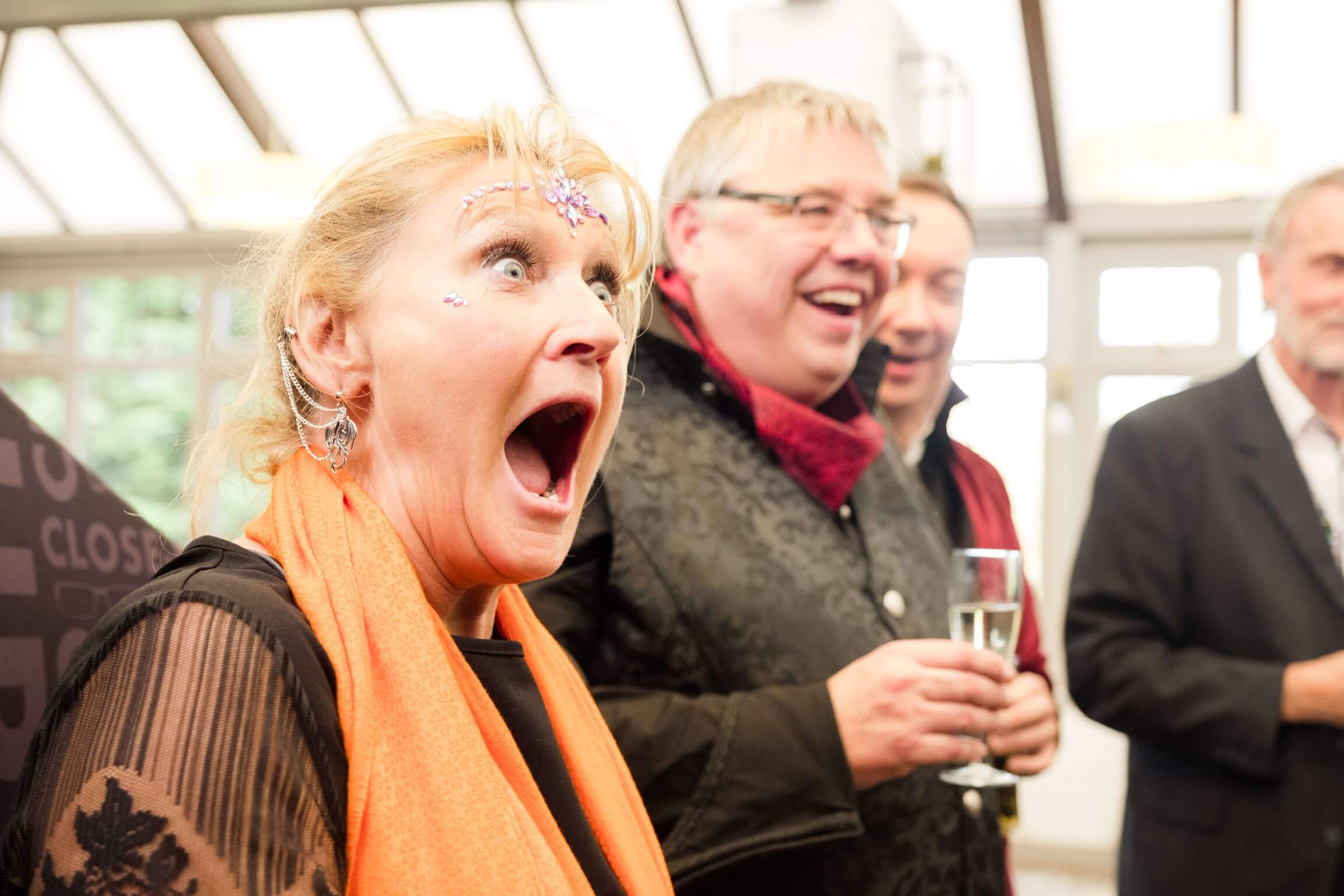 Guest reacting to a private close-up magic show in the Room of Mystery