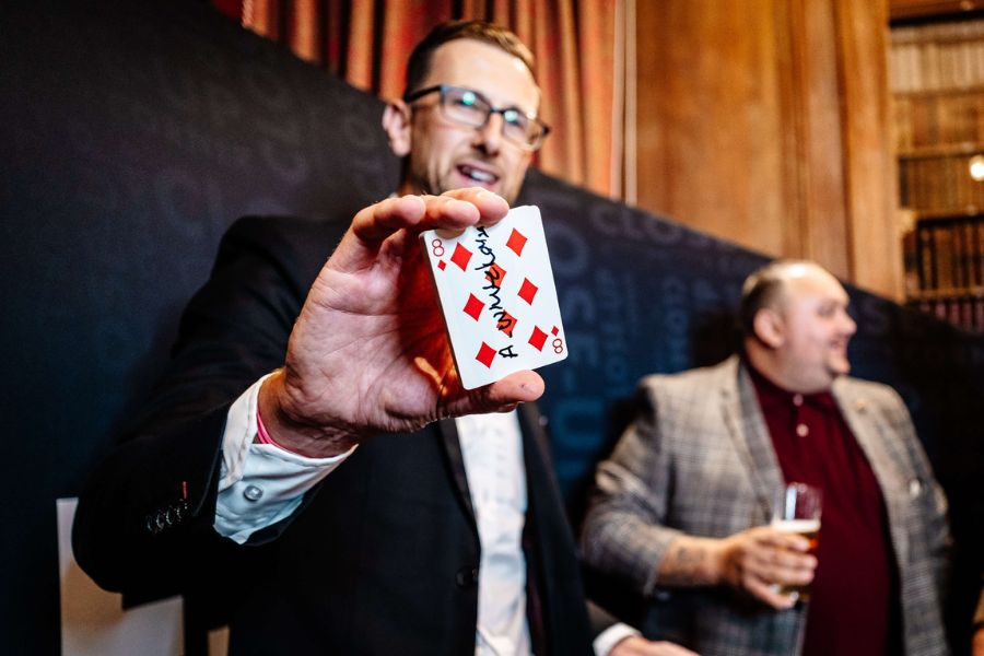 Close-Up Chris revealing the eight of diamonds at a wedding