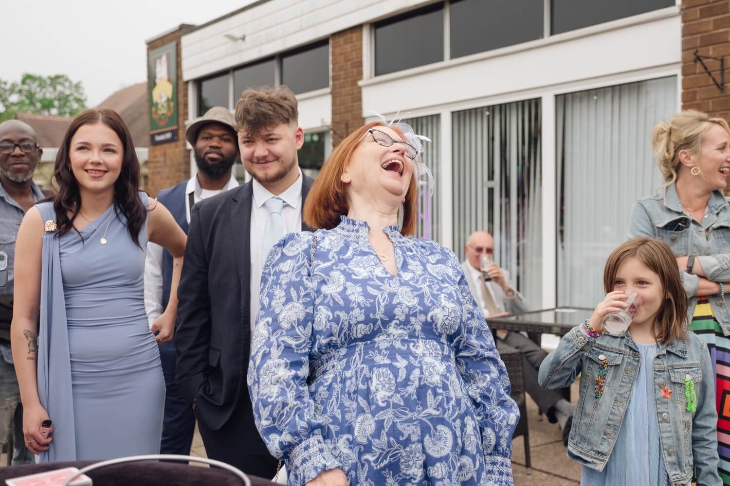 Wedding guest Ruth laughing at a close-up magic trick